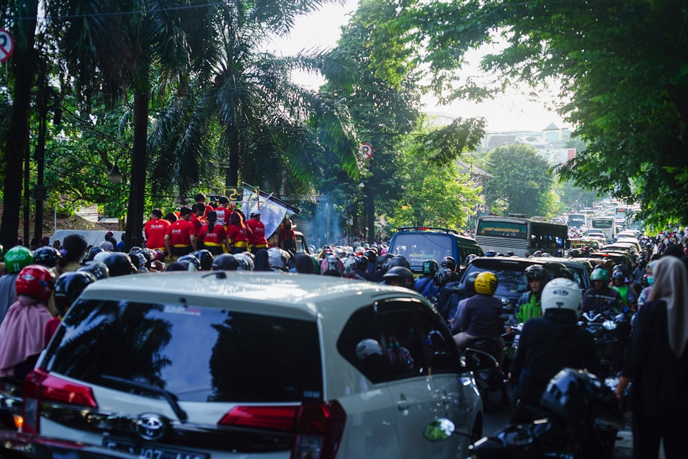 a large group of people riding motorcycles down a street