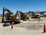 Dump trucks lined up at a construction site ready for work.