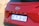A red Hyundai Creta with prominent branding on its rear, including a visible license plate from Gauteng, South Africa. The vehicle's design features sharp lines and a modern aesthetic, with a shiny surface reflecting natural light.