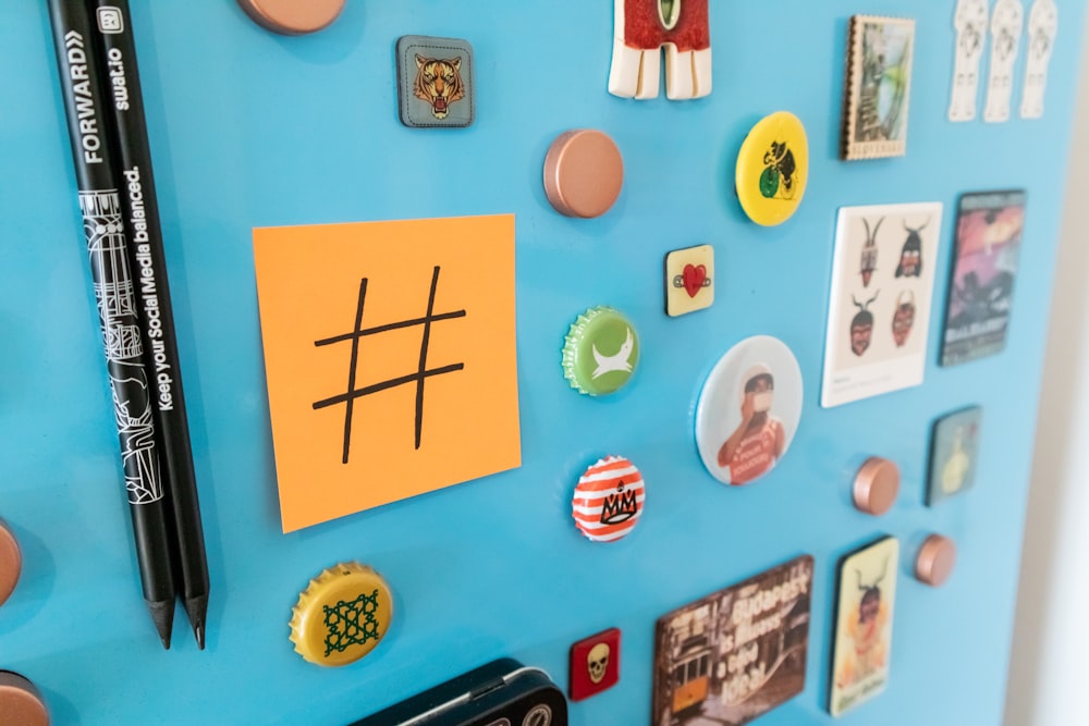 a bulletin board with magnets and a pen on it