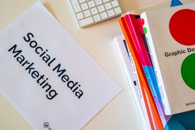 a sign that says social media marketing next to a keyboard