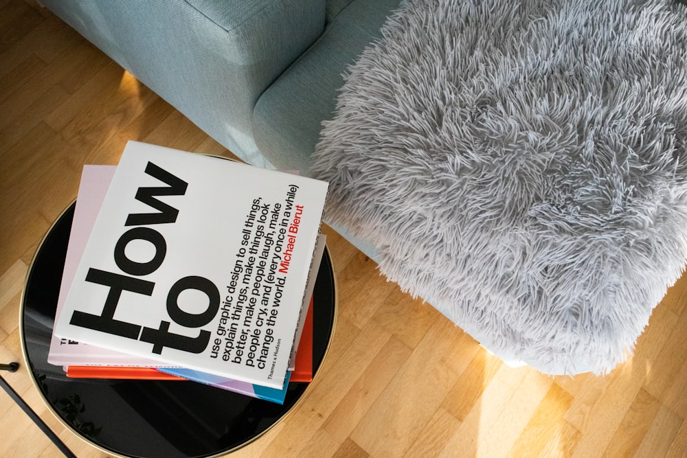 a book sitting on top of a table next to a chair