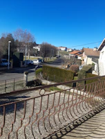 View of a peaceful neighborhood street with well-kept homes under a clear sky.