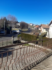 A neighborhood street with well-maintained homes under blue sky.