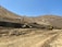 A construction site with heavy machinery operating efficiently under a clear blue sky.