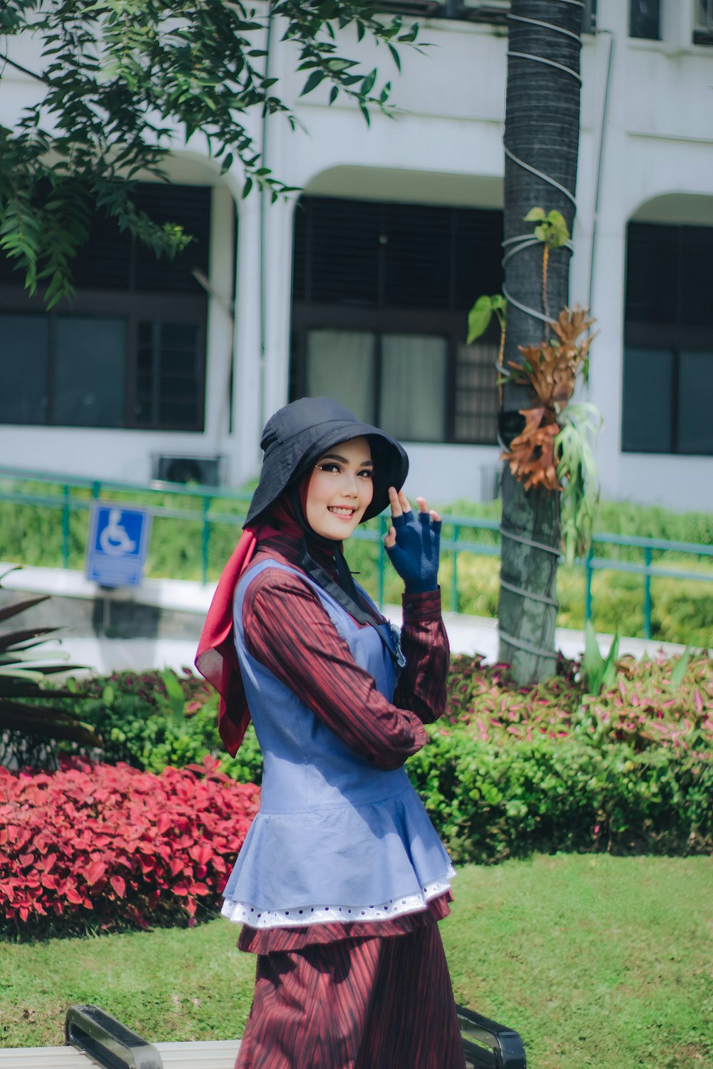 a woman in a costume is walking on a sidewalk