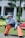 A happy customer wearing stylish casual clothing in a park.