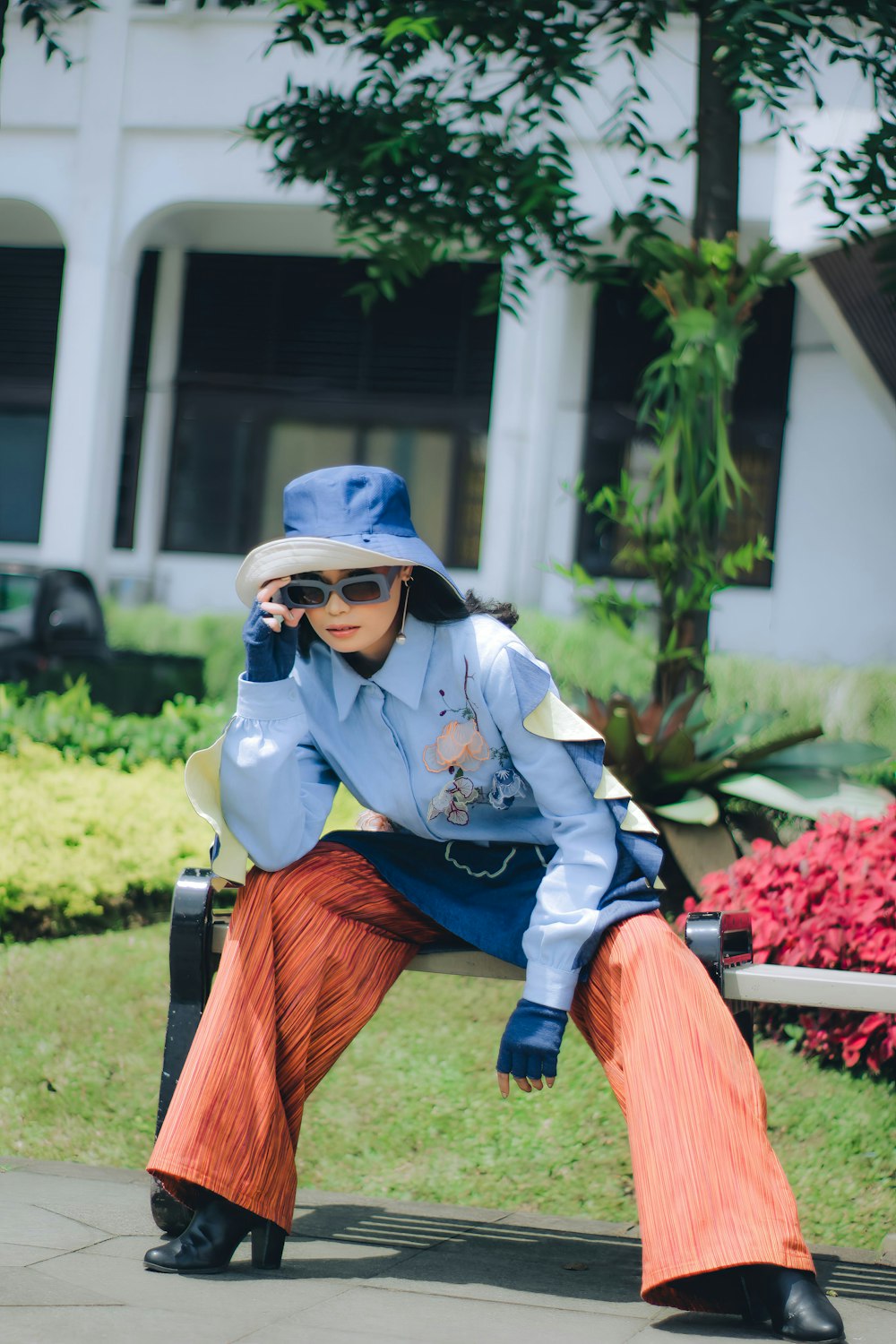 a woman sitting on a bench talking on a cell phone