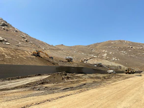 Construction vehicles on hilly terrain
