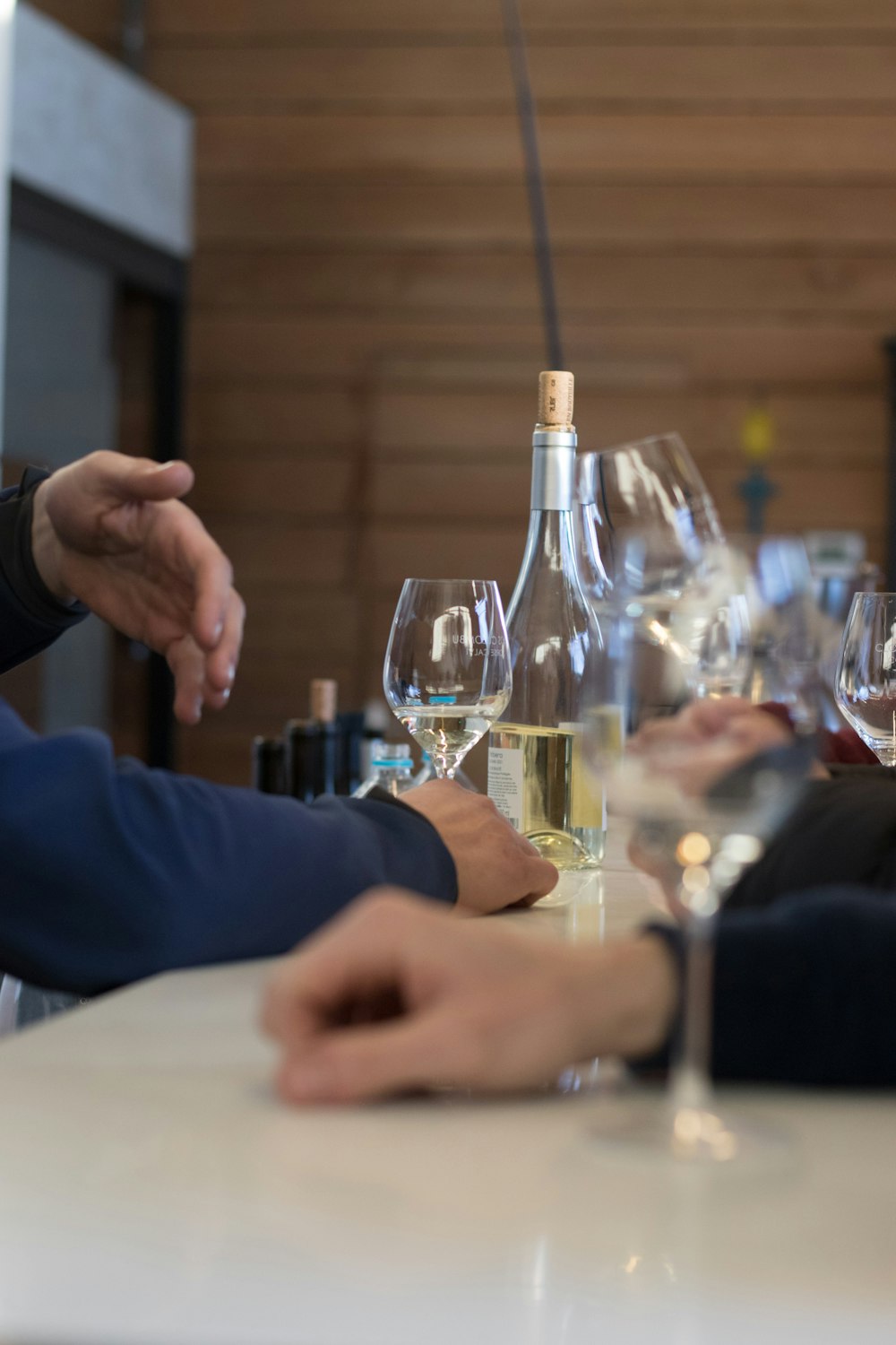 a group of people sitting at a table with wine glasses