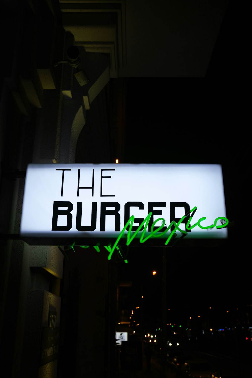 a neon sign that reads the burger place