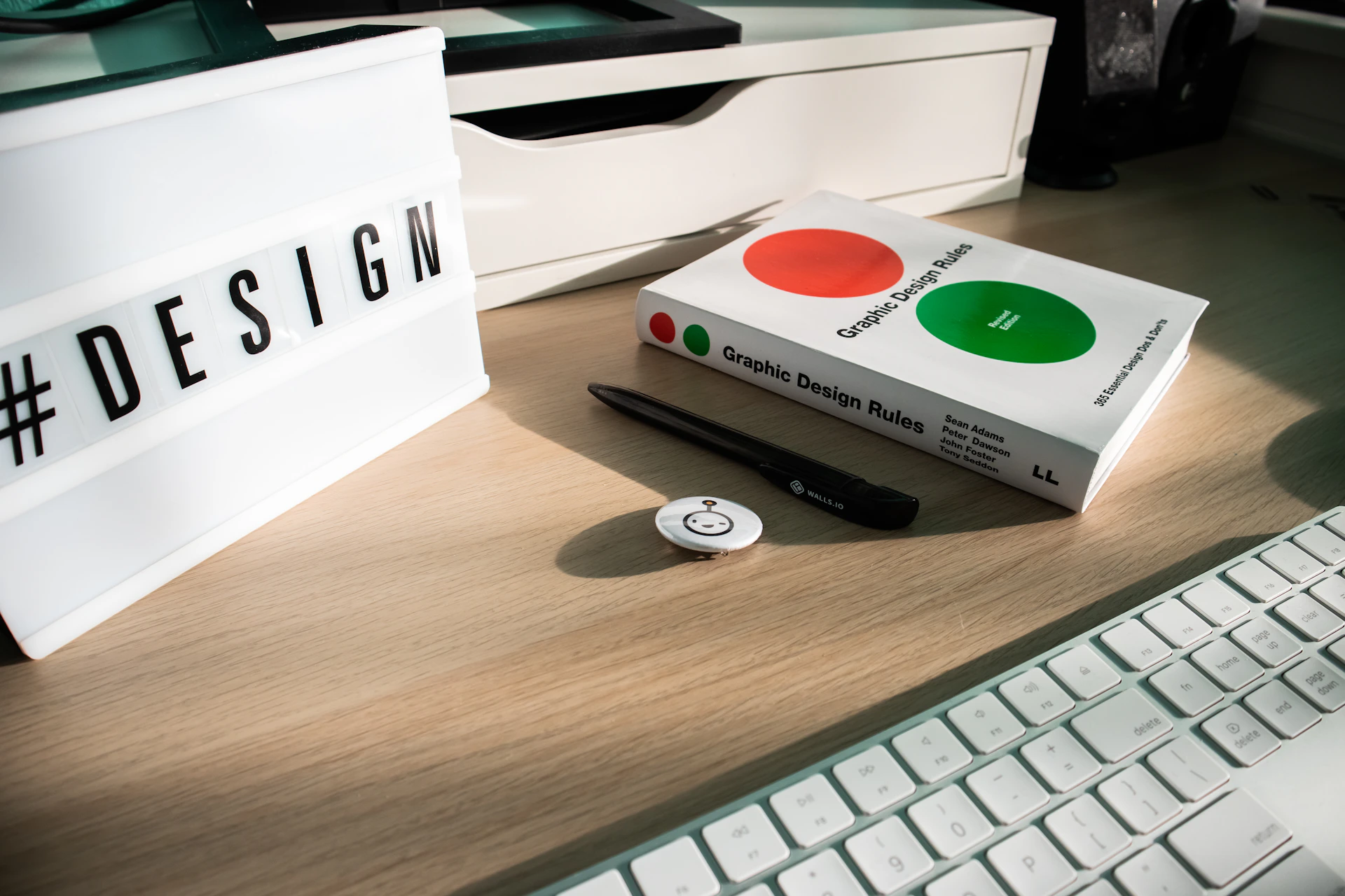 a desk with a keyboard and a book on it
