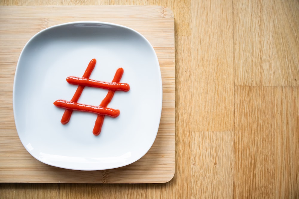 a white plate topped with carrots on top of a wooden table