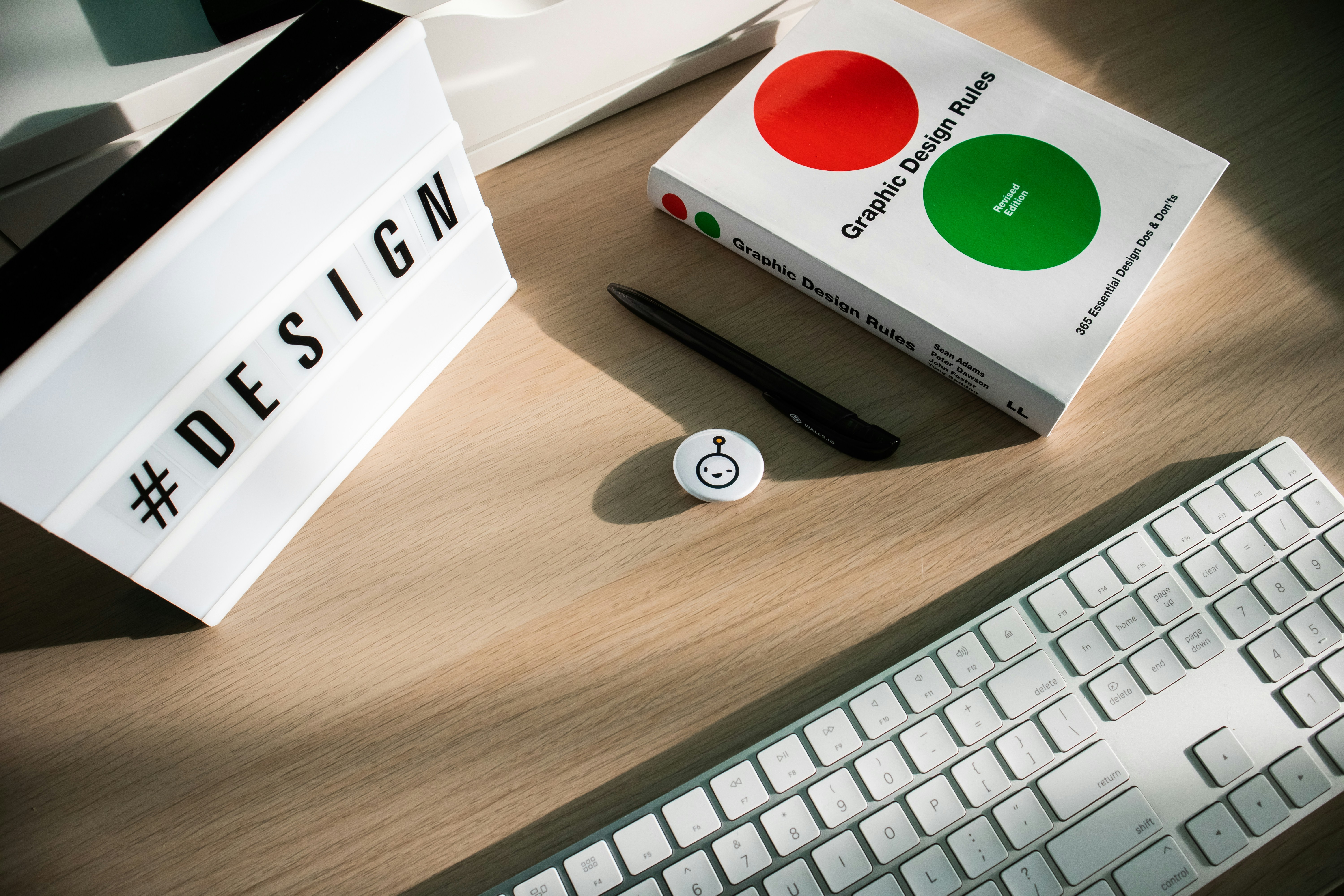 a keyboard, mouse, and box sitting on a desk
