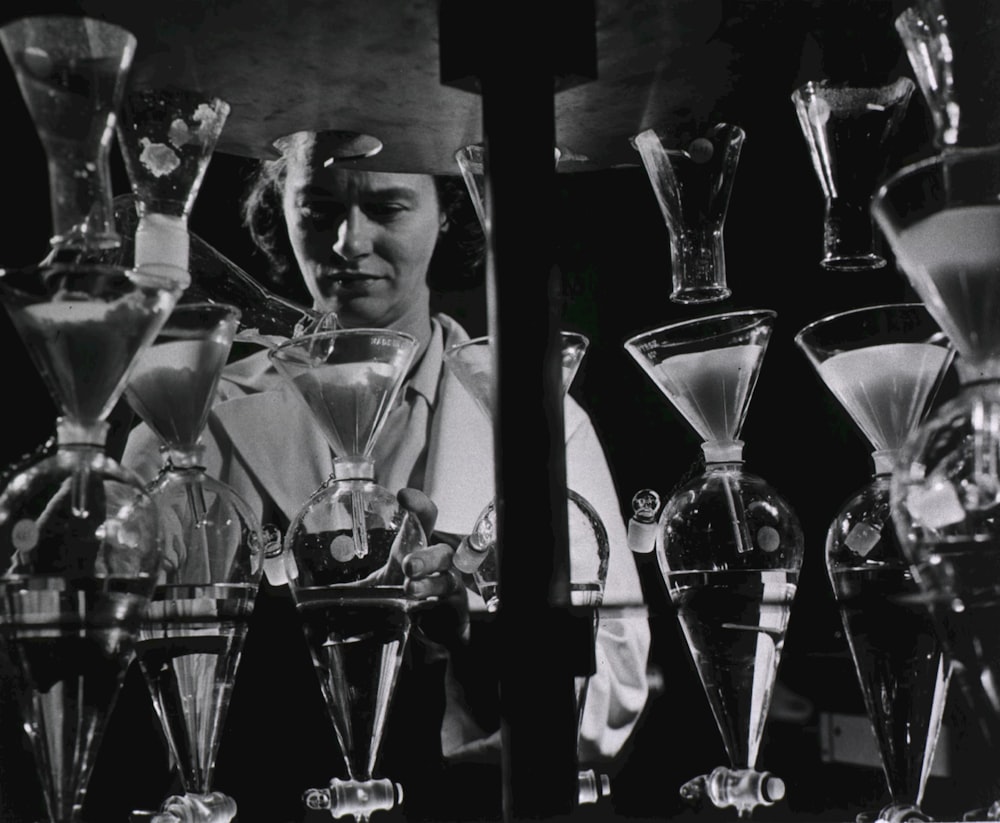 a man standing in front of a counter filled with glasses