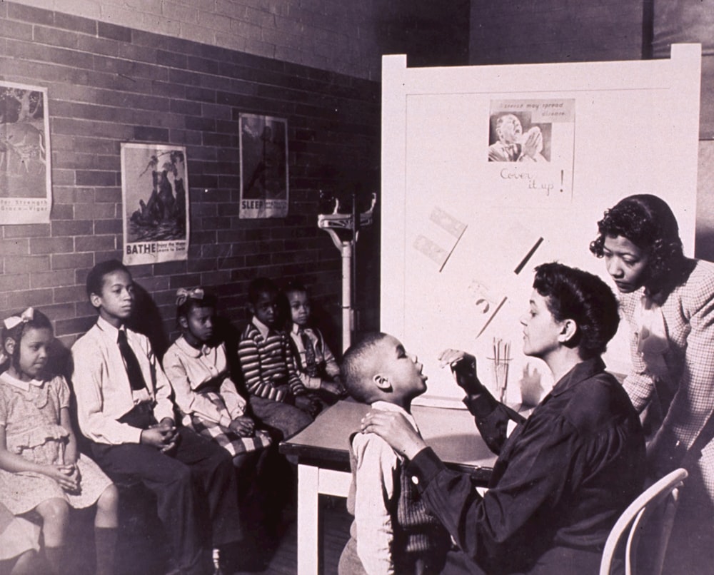 a black and white photo of a group of children