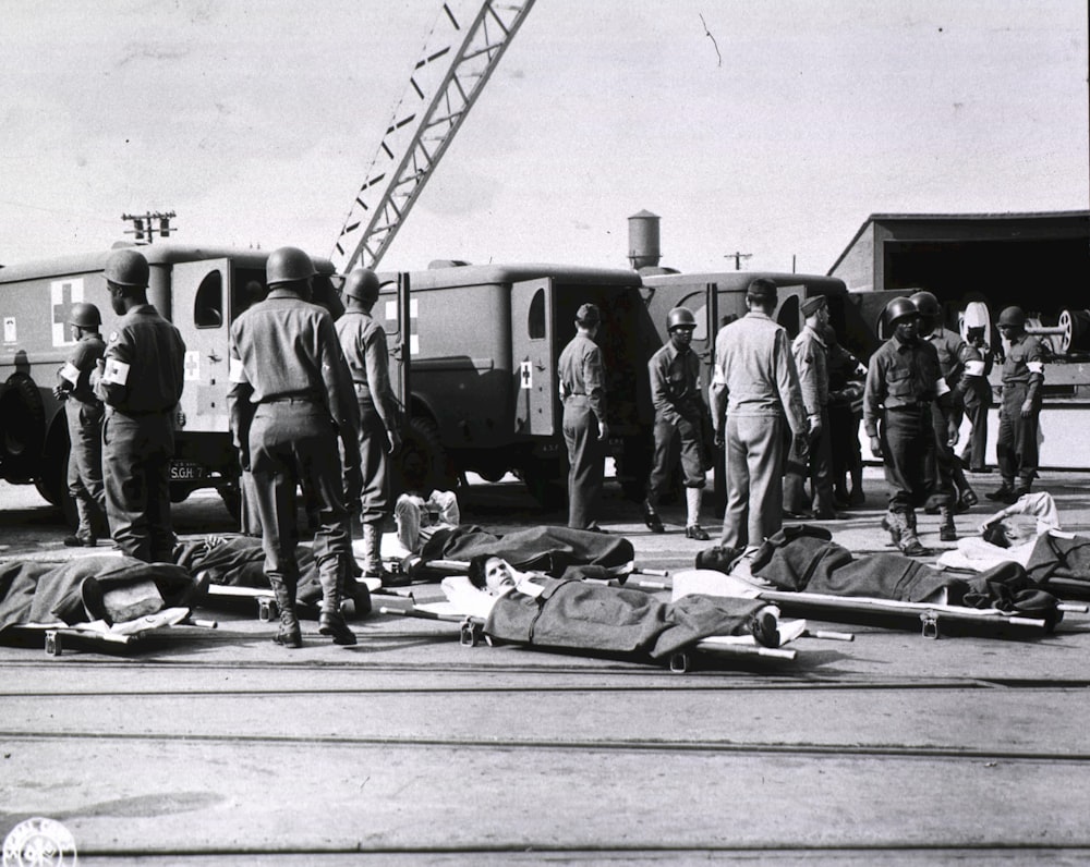 a group of men standing around a group of dead people