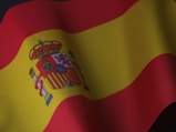 the flag of spain is waving in the wind