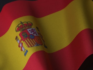the flag of spain is waving in the wind