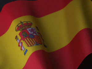 the flag of spain is waving in the wind