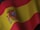 the flag of spain is waving in the wind