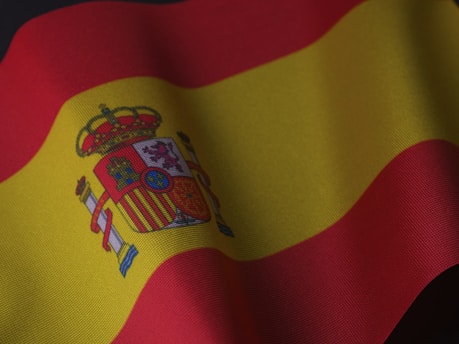 the flag of spain is waving in the wind