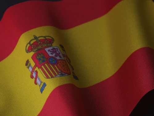 the flag of spain is waving in the wind
