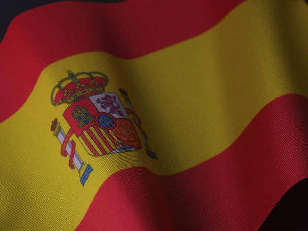the flag of spain is waving in the wind