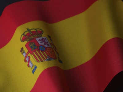 the flag of spain is waving in the wind