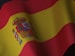 the flag of spain is waving in the wind