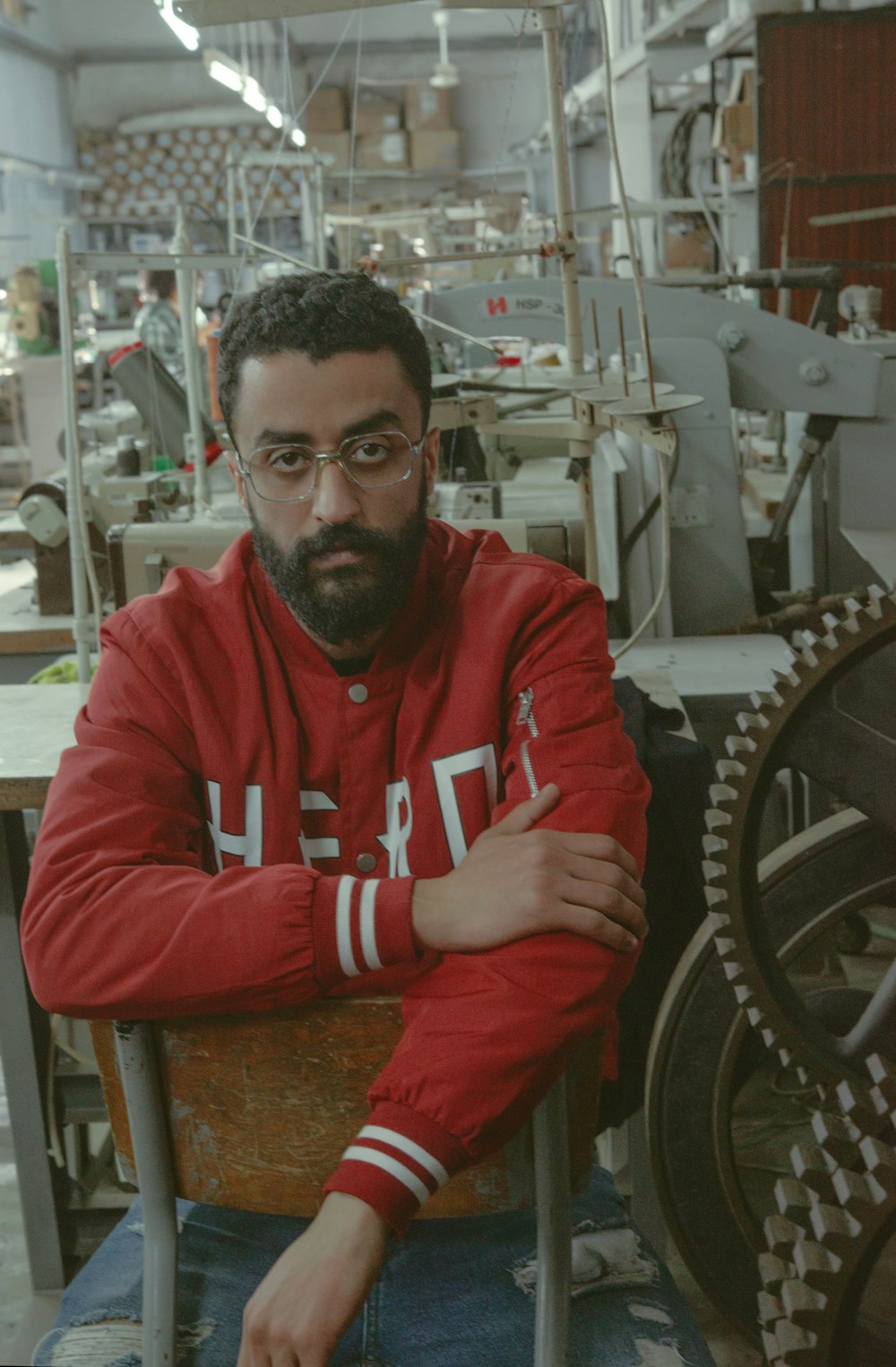 a man sitting in a chair in a factory