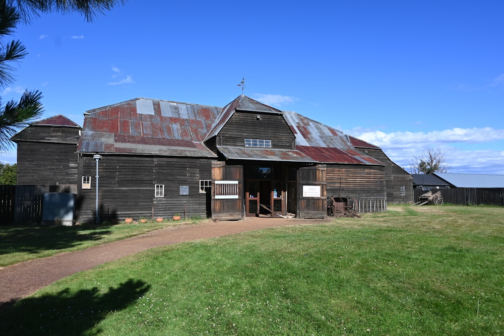 an old barn with a red tin roof