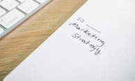 a notepad with the words marketing strategy written on it