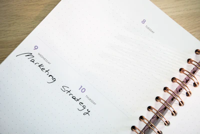 a planner with a pen on top of it