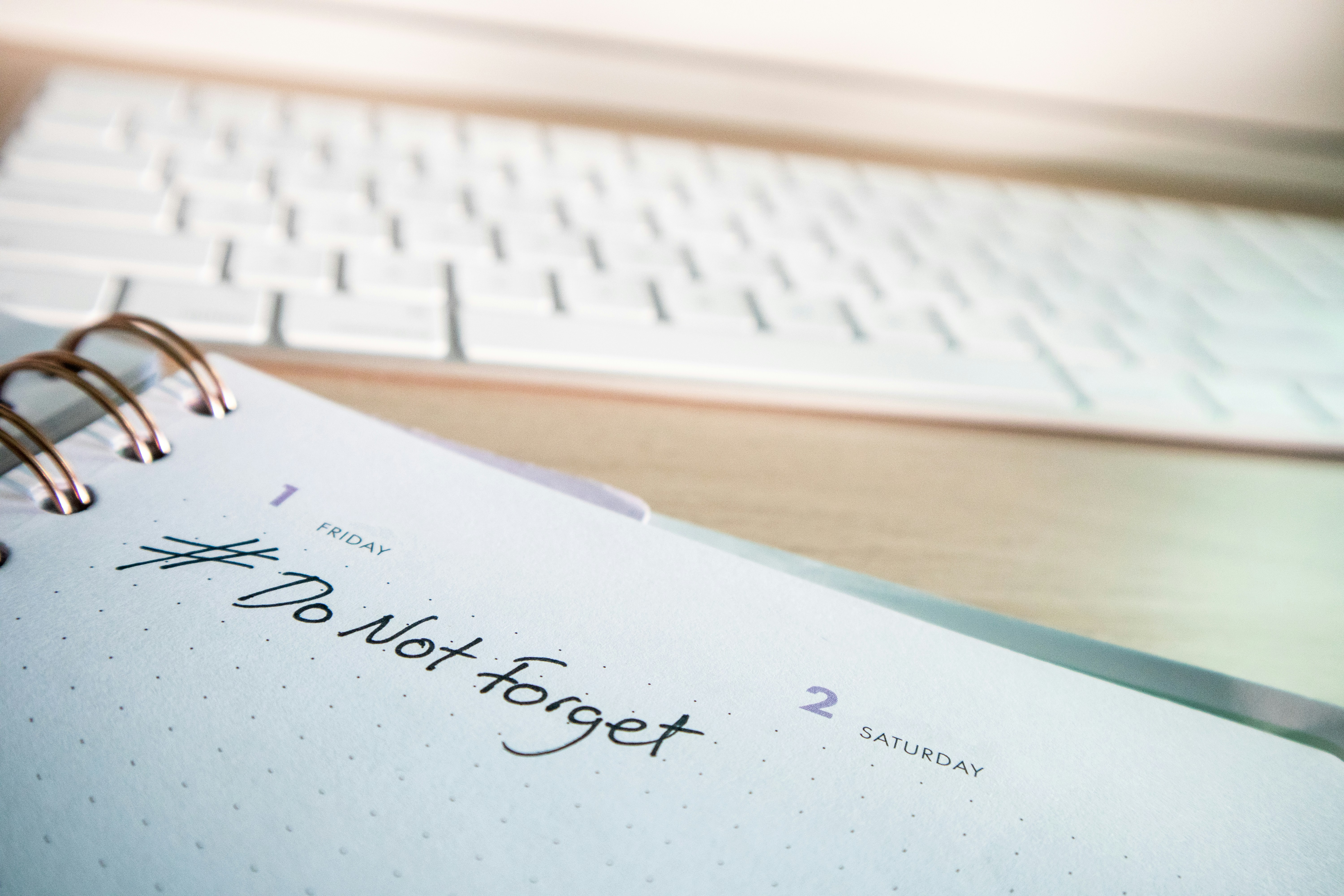 a notepad with a notepad next to a keyboard
