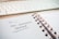 A close-up of a spiral-bound notebook open to a page with 'User-Generated Content' written on it in black ink. The page indicates it's Tuesday, the 22nd, and the notebook lies on a desk beside a white computer keyboard.