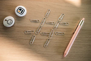 Close-up of Inkspire's premium staplers and paper clips on a wooden table.