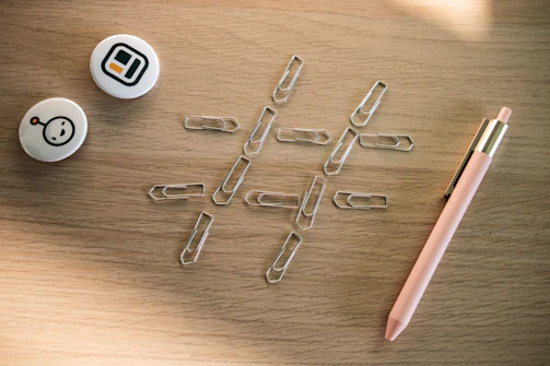 Close-up of Inkspire's premium staplers and paper clips on a wooden table.