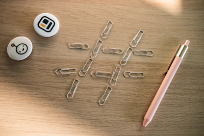 A set of colorful stickers and pins showcasing piercecc designs scattered on a desk