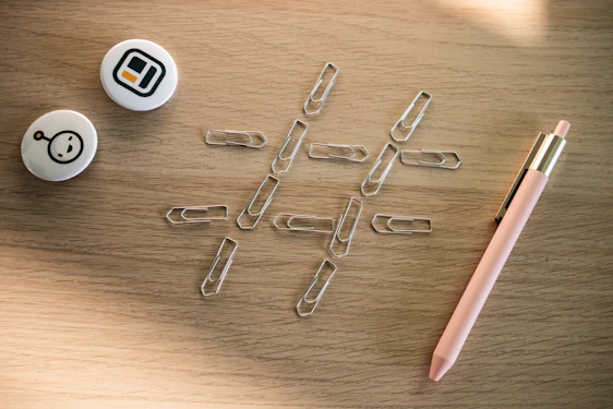A bright, lively office desk featuring colorful paper clips, push pins, and mel’s box products arranged neatly.