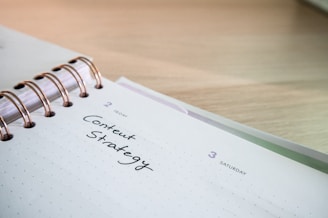 a notepad with a spiral notebook on top of it