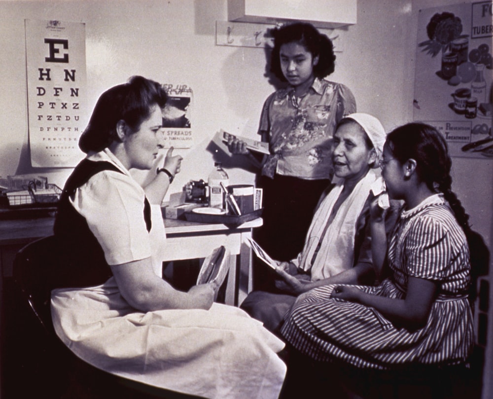 a group of women sitting around a table