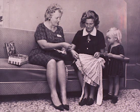 a woman and two children sitting on a couch