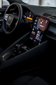 a car dashboard with a cell phone in the center