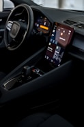 a car dashboard with a cell phone in the center