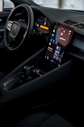 a car dashboard with a cell phone in the center