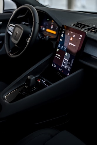 a car dashboard with a cell phone in the center