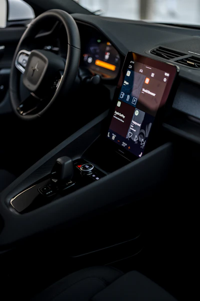 a car dashboard with a cell phone in the center