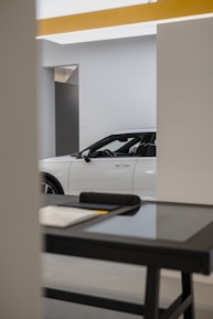 Close-up of hands exchanging car keys in a minimalist, modern office setting.