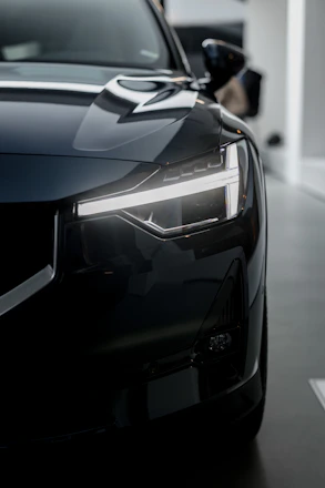 A sleek, modern car being carefully inspected before shipment.